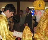 Acolyte, Nick Rolston, held the Prayer Book for His Eminence so he could read the prayers during the 